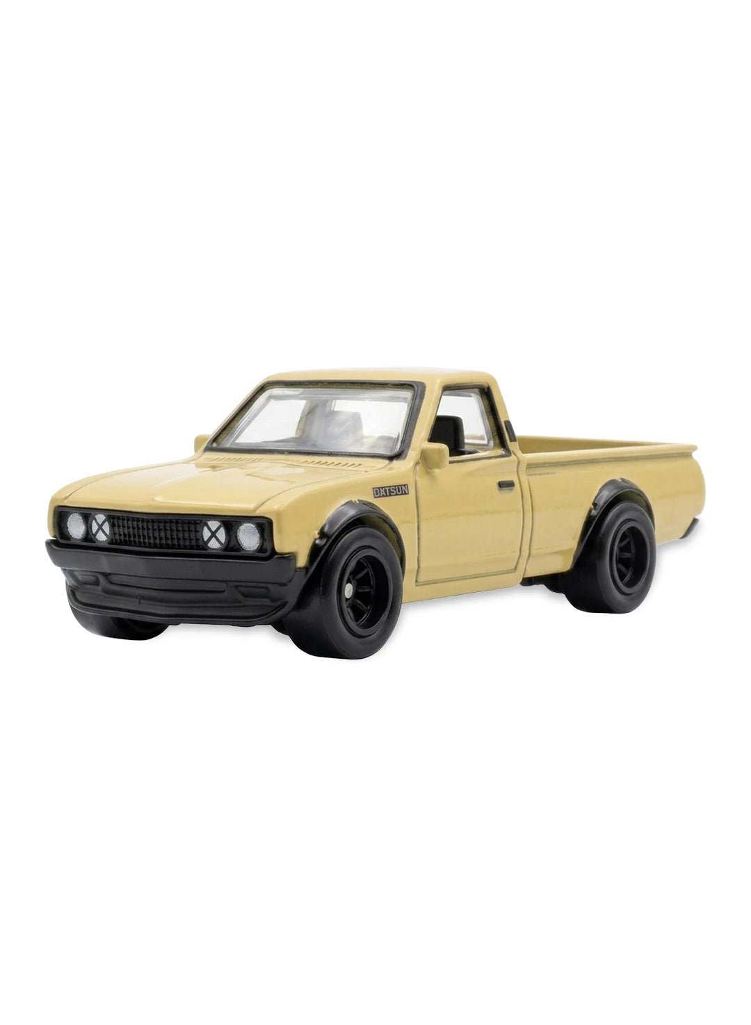 Close-up view of the tan beige Hot Wheels Datsun 620 pickup truck showing clean side profiles and detailed multi-spoke dark grey Real Riders wheels.