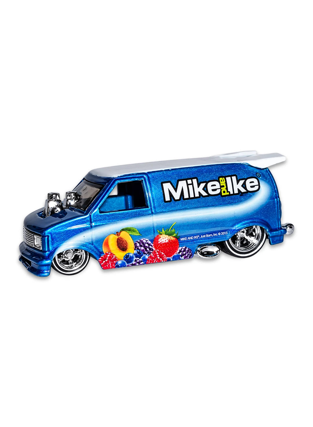 Close-up view of the metalflake blue Hot Wheels Mike and Ike Astro Van showing side fruit graphics, white roof, and chrome Real Riders wheels.