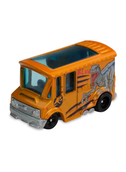 Close-up view of the orange Hot Wheels Velociraptor Blue Bread Box van showing dinosaur graphics and black wheels.