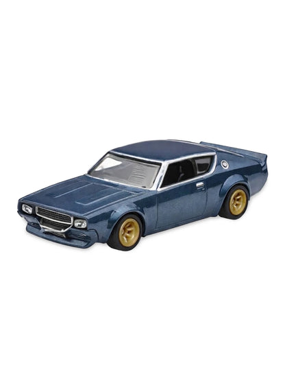 Close-up view of the metalflake dark blue Hot Wheels Nissan Skyline 2000GT-R LBWK car showing widebody fenders and copper-colored multi-spoke Real Riders wheels.