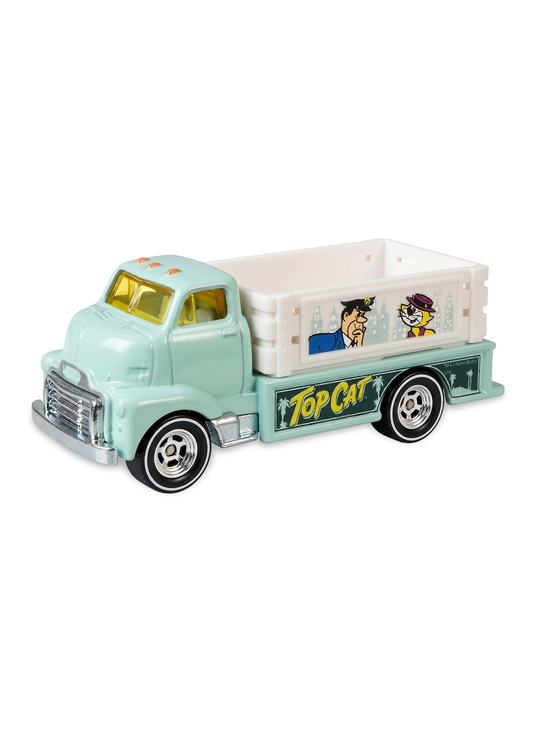 Close-up view of the light green and white Hot Wheels Top Cat 1951 GMC COE truck showing side graphics and white-wall Real Riders wheels.