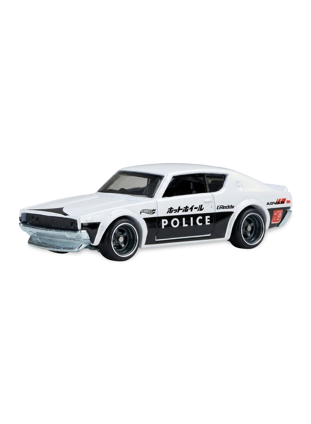 Close-up view of the two-tone white and black Hot Wheels Japanese Police Nissan Skyline 2000GT-R showing side decals and steelie wheels.