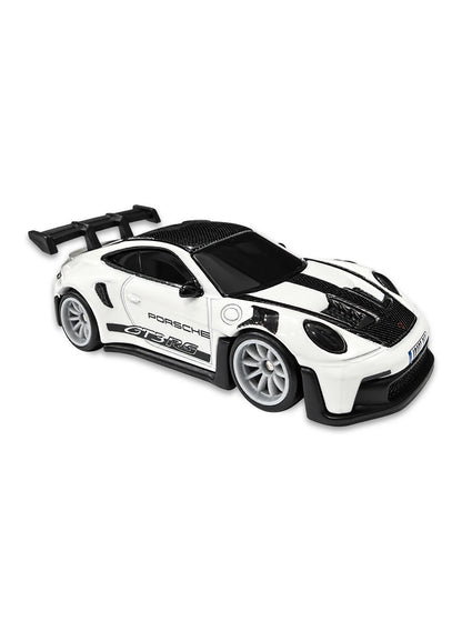 Close-up view of the white Hot Wheels Gran Turismo 2022 Porsche GT3 RS showing side black GT3 RS door graphics, an aggressive rear wing aero kit, and silver multi-spoke Real Riders wheels.