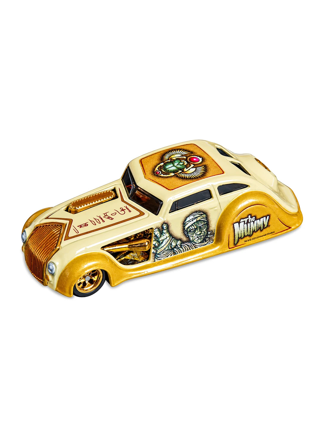 Close-up view of the mustard yellow Hot Wheels 2013 Universal Monsters The Mummy 1934 Chrysler Airflow showing side graphics and gold Real Riders wheels.