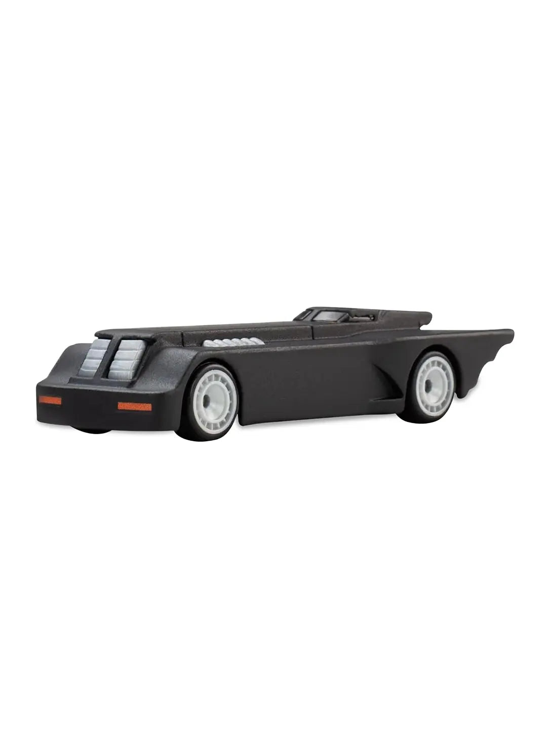Close-up view of the matte black Hot Wheels Batman The Animated Series Batmobile showing an elongated geometric body shape, exhaust port details, and silver disc Real Riders wheels.