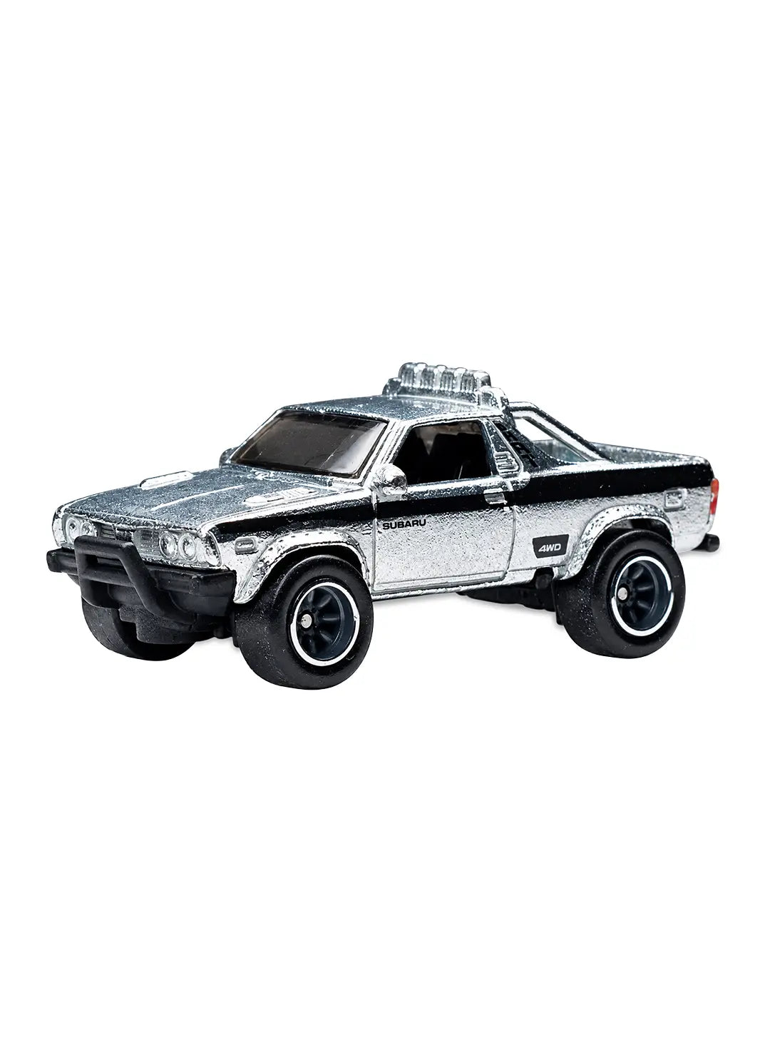 Close-up view of the metalflake silver Hot Wheels Subaru Brat showing black upper body graphics, a silver plastic roll bar with rear jump seats, and 8-spoke dark grey Real Riders wheels.