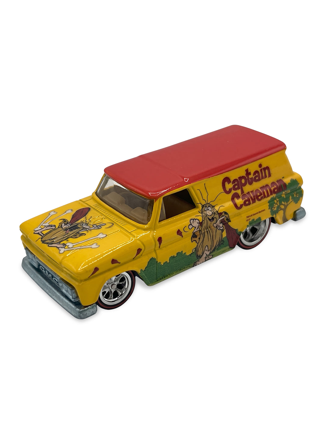 Close-up view of the yellow and red Hot Wheels Captain Caveman '64 GMC Panel truck showing side character graphics and chrome Real Riders wheels.