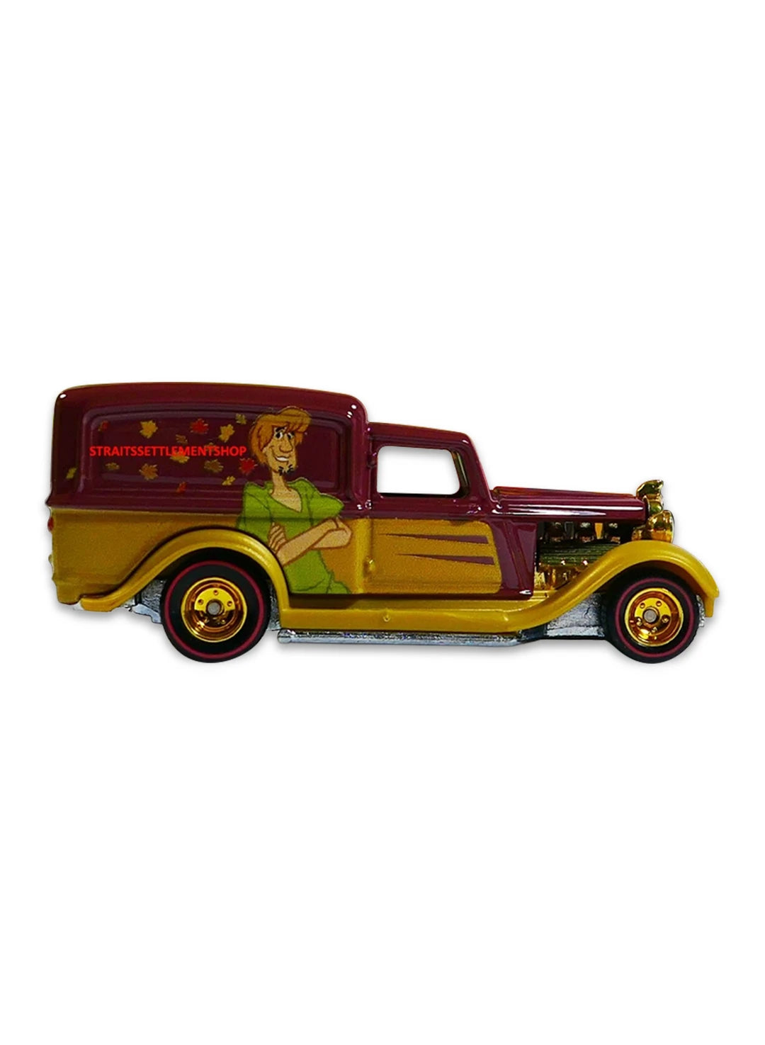 Close-up view of the metallic burgundy Hot Wheels Shaggy '34 Dodge Delivery truck showing tan panels and gold chrome Real Riders wheels.