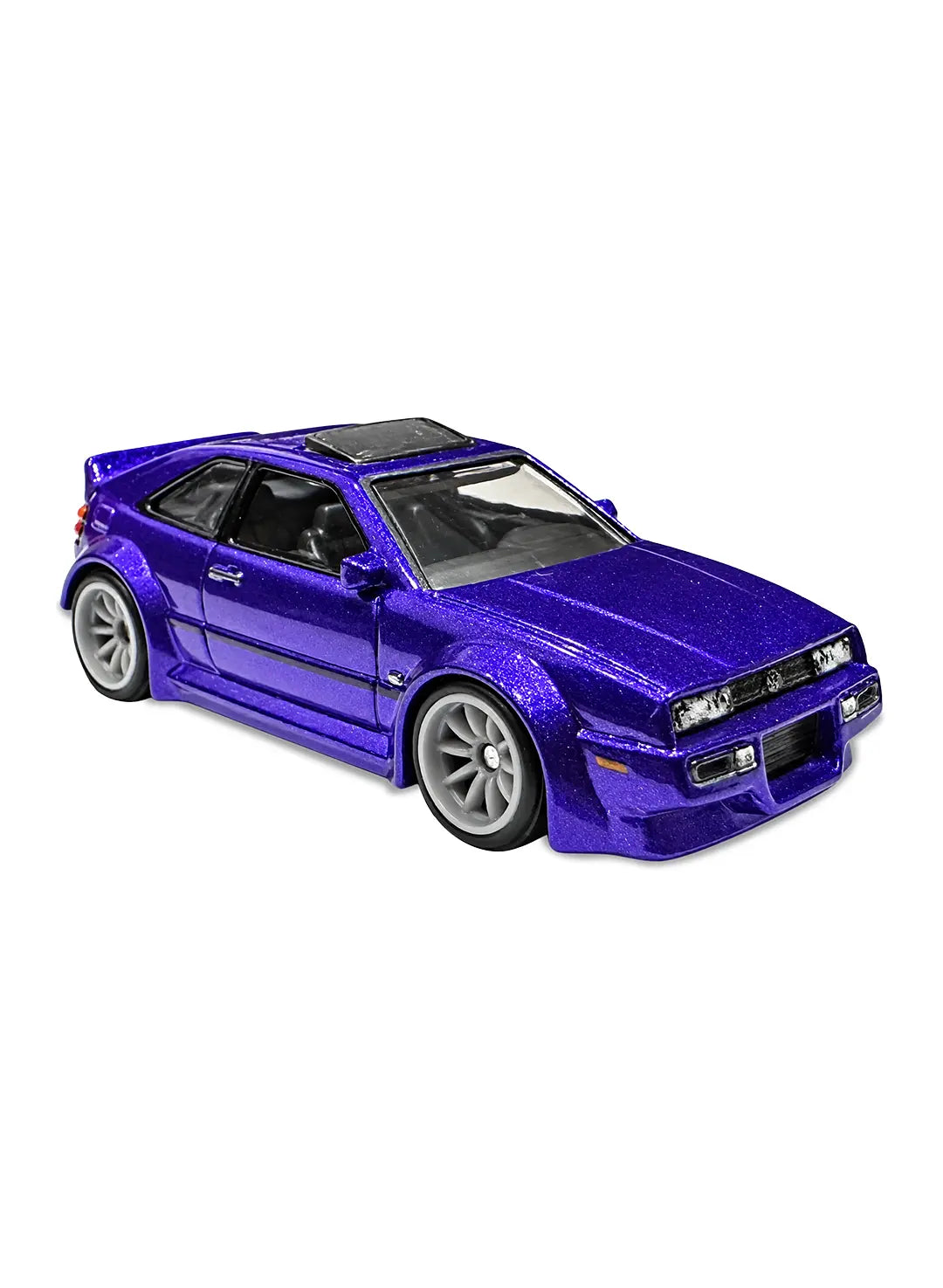 Close-up quarter view of the premium royal violet Volkswagen Corrado VR6 highlighting its sleek sport compact hatch lines, detailed headlight trims, clean factory badges, and dark multi-spoke RR10SPM Real Riders wheels.