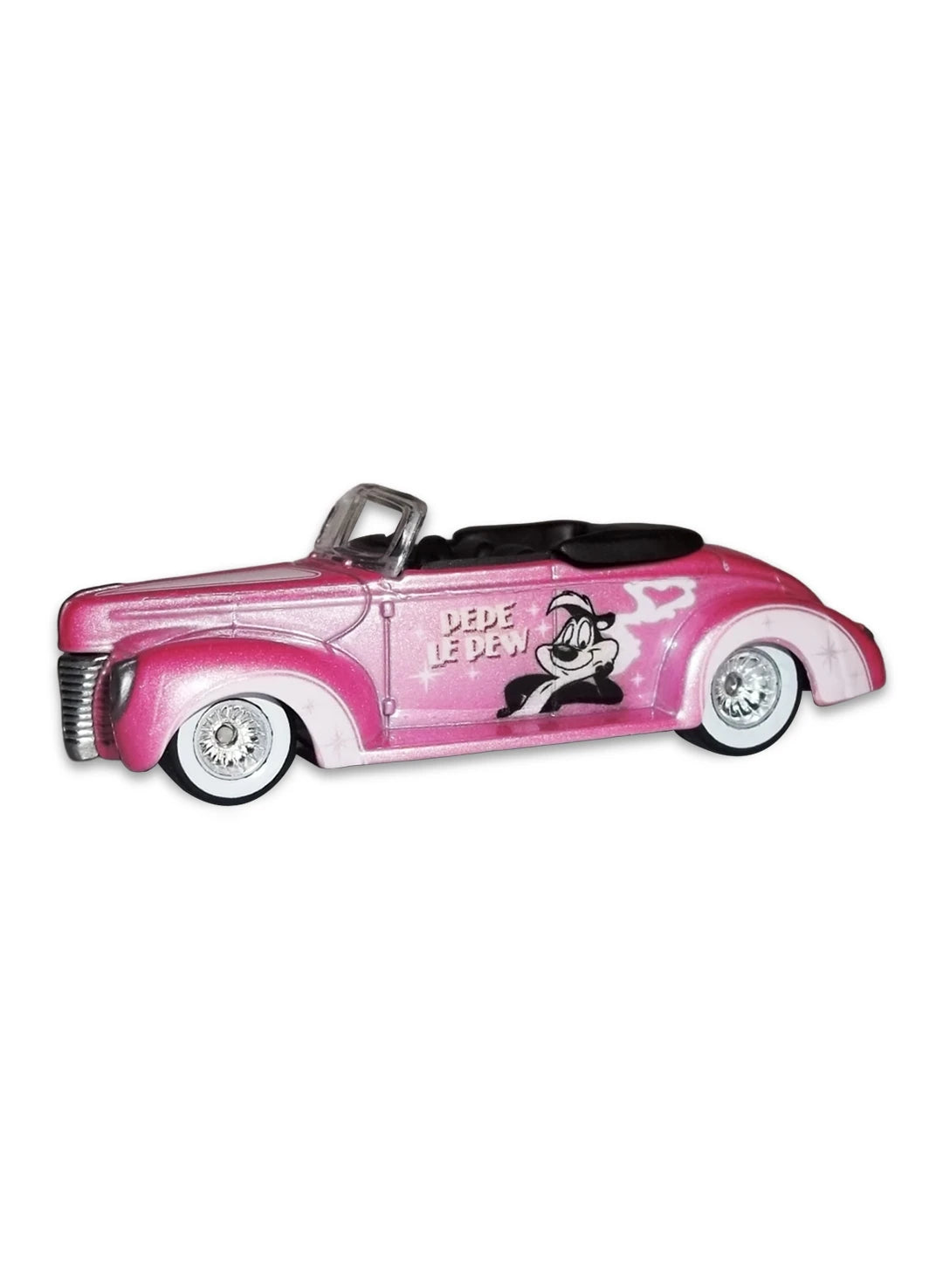 Close-up view of the pink and white Hot Wheels 2013 Pepé Le Pew '40 Ford Convertible showing side graphics and white-wall Real Riders wheels.