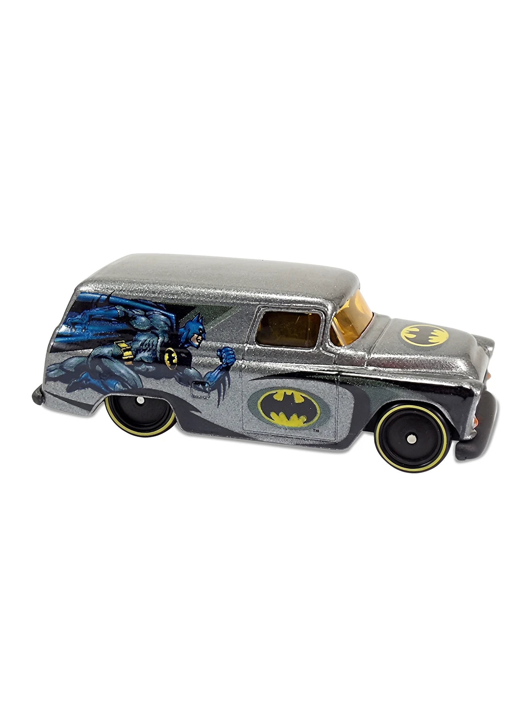 Close-up view of the silver Hot Wheels Batman '55 Chevy Panel truck showing side character graphics and yellow-rimmed Real Riders wheels.