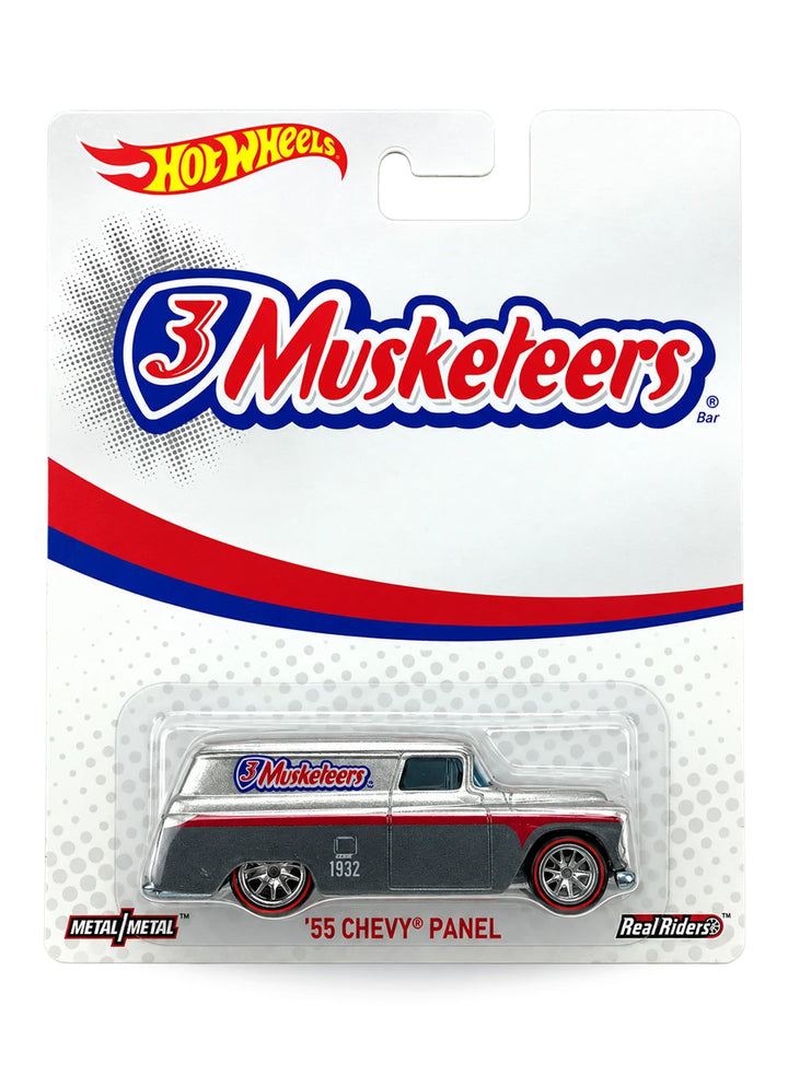 Close-up view of the yellow Hot Wheels M&M's Volkswagen Drag Bus showing a chocolate brown roof, side logos, and chrome Real Riders wheels.