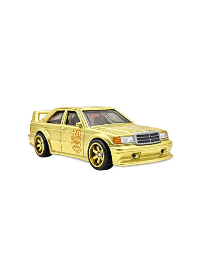 Close-up view of the rare limited-edition premium gold Hot Wheels Mercedes-Benz 190 E Evo II Chase car emphasizing its high DTM touring wing spoiler, aggressive body kit panel sweeps, fine grille detailing, and black multi-spoke RR6SPM Real Riders wheels.