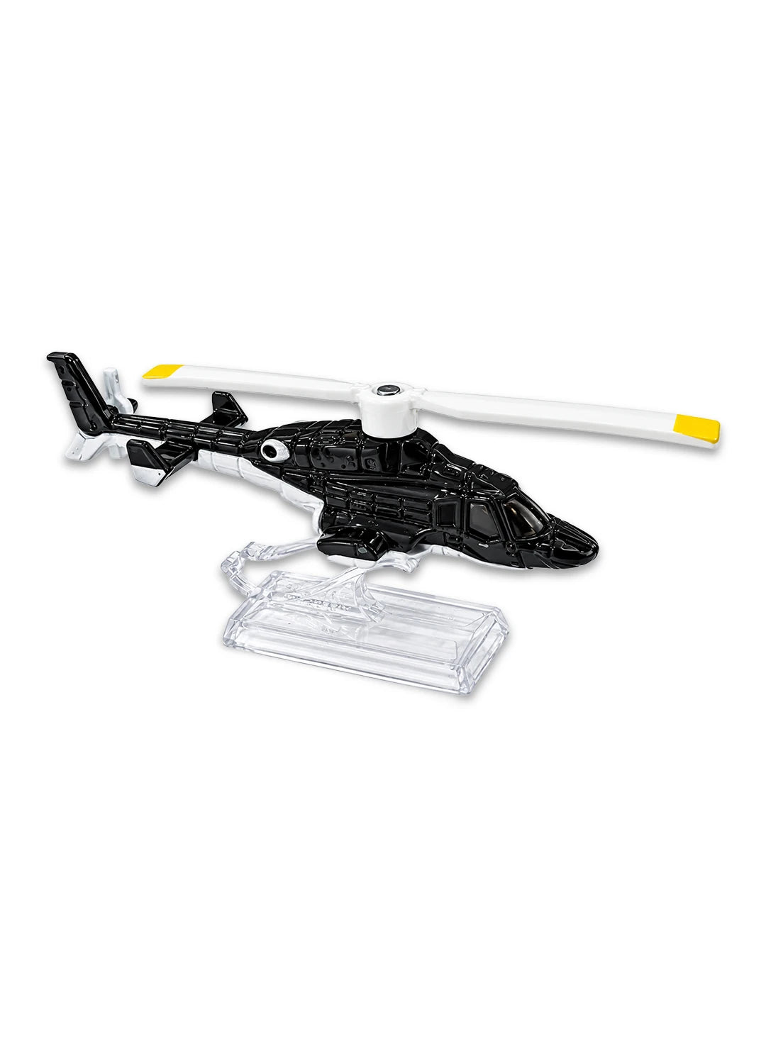 Close-up view of the dark grey and white Hot Wheels Airwolf helicopter showing a sleek aerodynamic fuselage, yellow tipped main rotor blades, and retractable scale landing gear details.