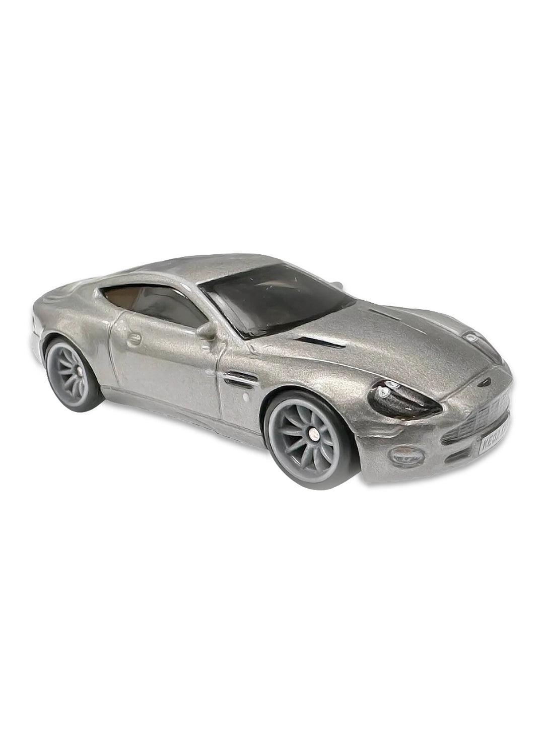 Close-up view of the sleek metallic silver Hot Wheels James Bond Aston Martin Vanquish coupe showing a detailed front grille, side fender vents, and grey split-spoke Real Riders wheels.