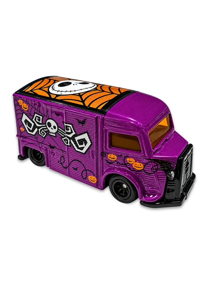 Close-up view of the metallic purple Hot Wheels Nightmare Before Christmas Citroën Type H van showing spooky Jack Skellington side graphics, orange pumpkin detailing, and blacked-out Real Riders wheels.