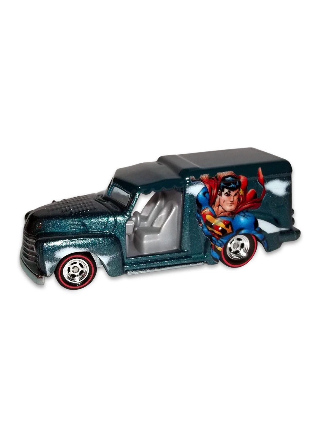 Close-up view of the metallic teal blue Hot Wheels Superman Custom '52 Chevy van showing side comic graphics and redline Real Riders wheels.