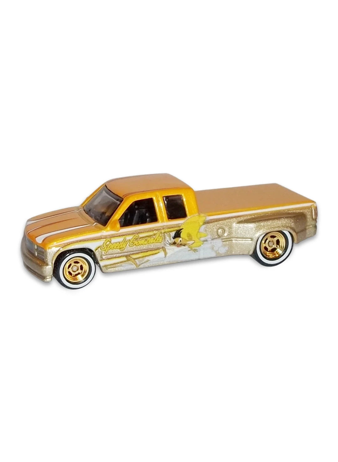 Close-up view of the yellow and silver Hot Wheels 2013 Speedy Gonzales Custom '98 Chevy C3500 dually truck showing side graphics and white-wall Real Riders wheels.