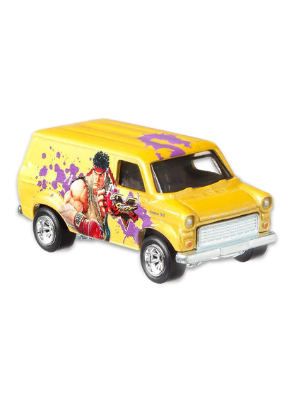 Close-up view of the bright yellow Hot Wheels Ryu Ford Transit Supervan showing side graffiti splash graphics and chrome Real Riders wheels.