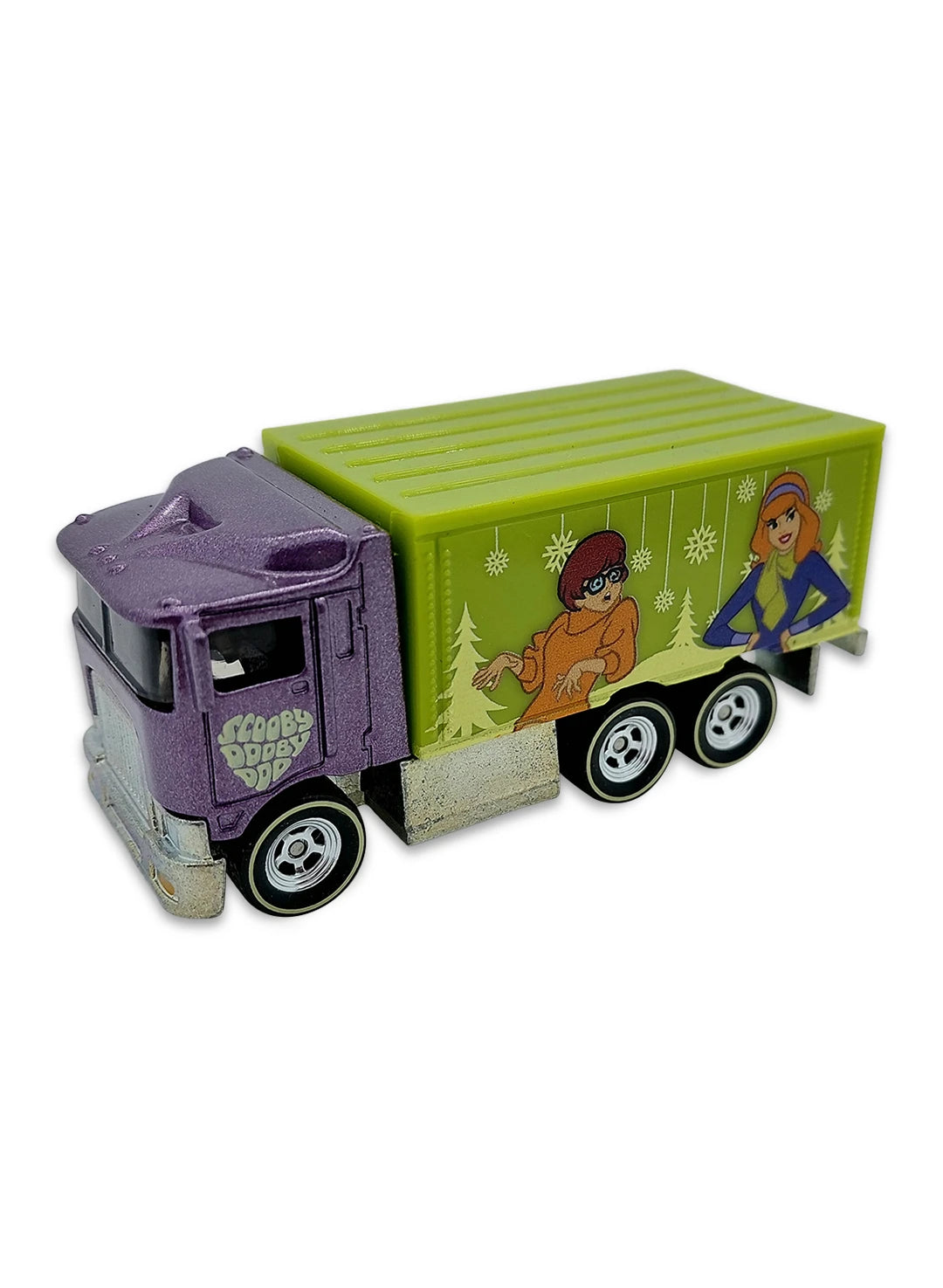 Close-up view of the dark purple Hot Wheels Daphne and Velma Hiway Hauler truck showing a green cargo box and chrome Real Riders wheels.